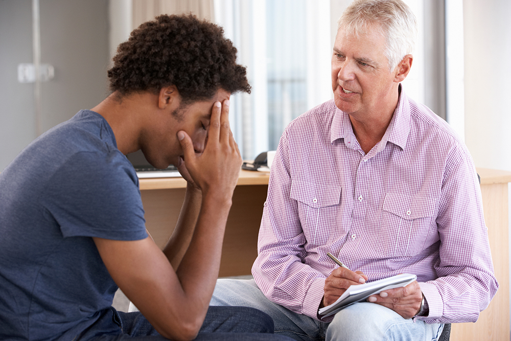 Man sitting with counselor