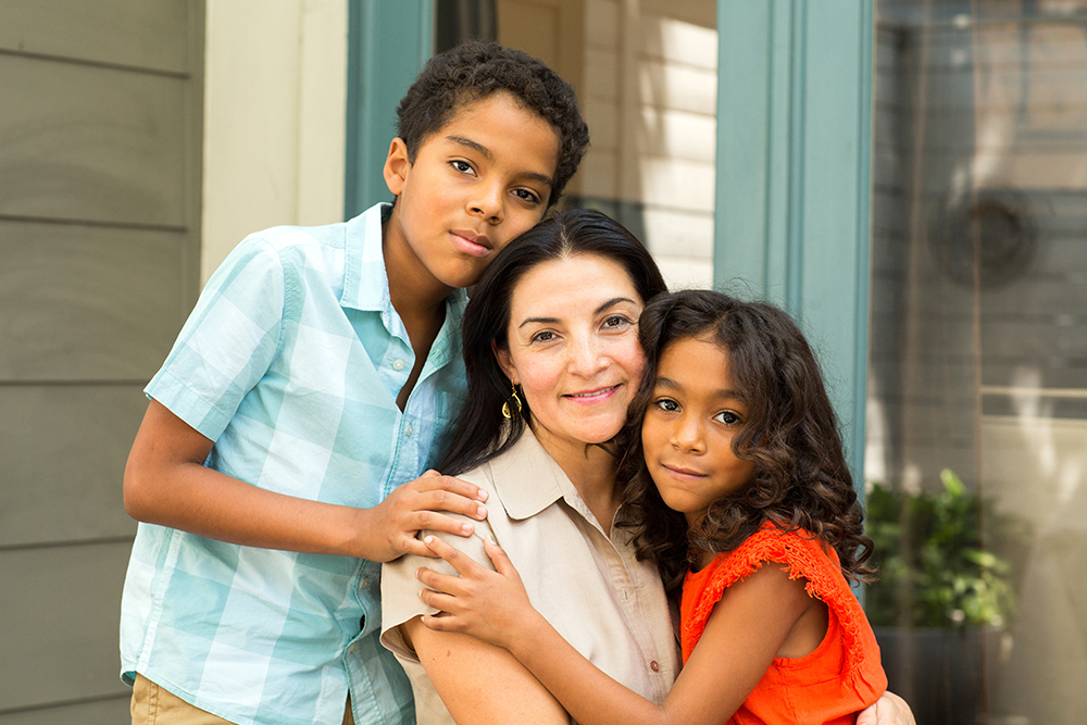 Mother smiling at camera with children